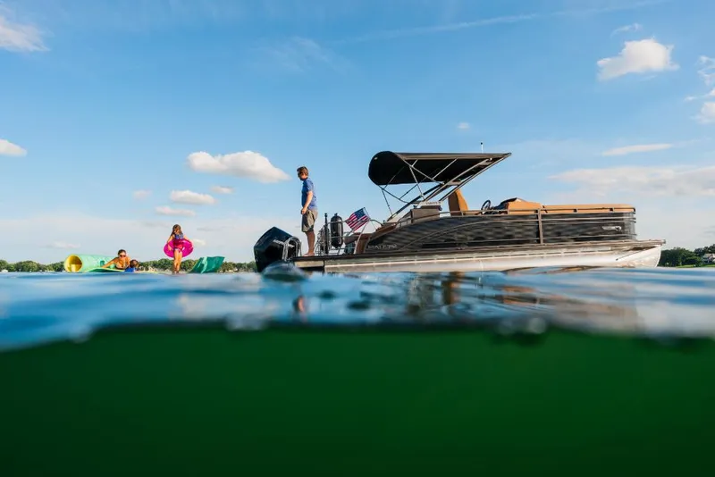 Slide: The Image of 2023 Harris Solstice 250 pontoon boat with people enjoying water activities. - 10