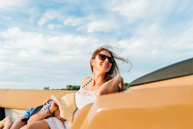 Slide: The Image of Woman enjoying a sunny day on a 2023 Harris Solstice 250 boat. - 14