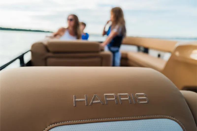 Slide: The Image of 2023 Harris Solstice 250 boat interior with family in the background. - 22