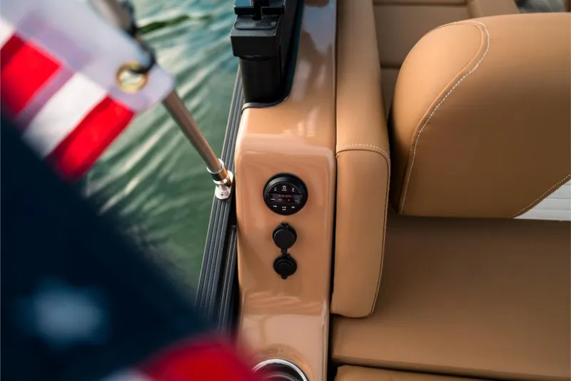 Slide: The Image of 2023 Harris Solstice 250 boat interior with tan leather seats and American flag. - 25