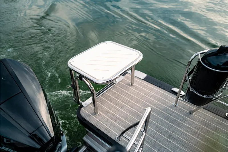 Slide: The Image of 2023 Harris Solstice 250 boat deck with motor on water. - 29