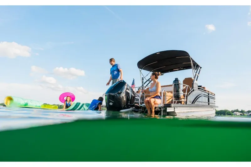 Slide: The Image of 2023 Harris Solstice 250 pontoon boat with people enjoying water activities. - 4