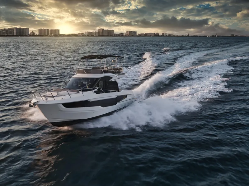 Slide: The Image of 2023 Galeon 400 Fly yacht cruising at sunset on open water. - 14
