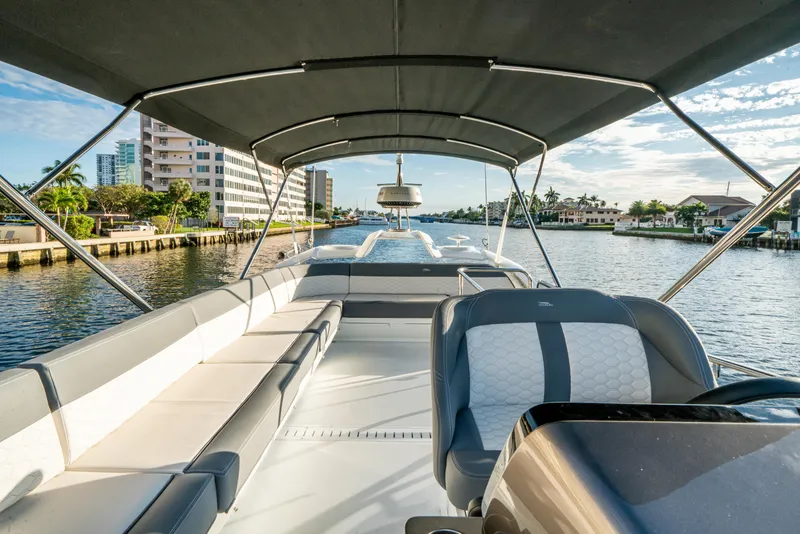 Slide: The Image of 2023 Galeon 400 Fly yacht interior with seating, cruising on a sunny waterway. - 17