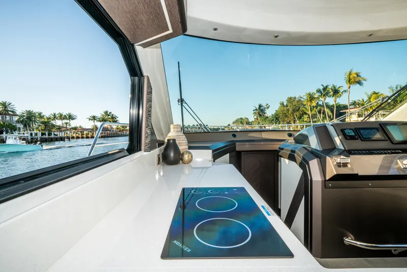 Slide: The Image of Interior view of 2023 Galeon 400 Fly yacht with modern kitchen and scenic waterway. - 23