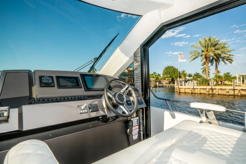 Slide: The Image of Interior view of 2023 Galeon 400 Fly yacht cockpit with waterfront scenery. - 25