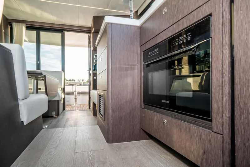 Slide: The Image of Interior of 2023 Galeon 400 Fly yacht, featuring modern kitchen appliances and sleek design. - 27