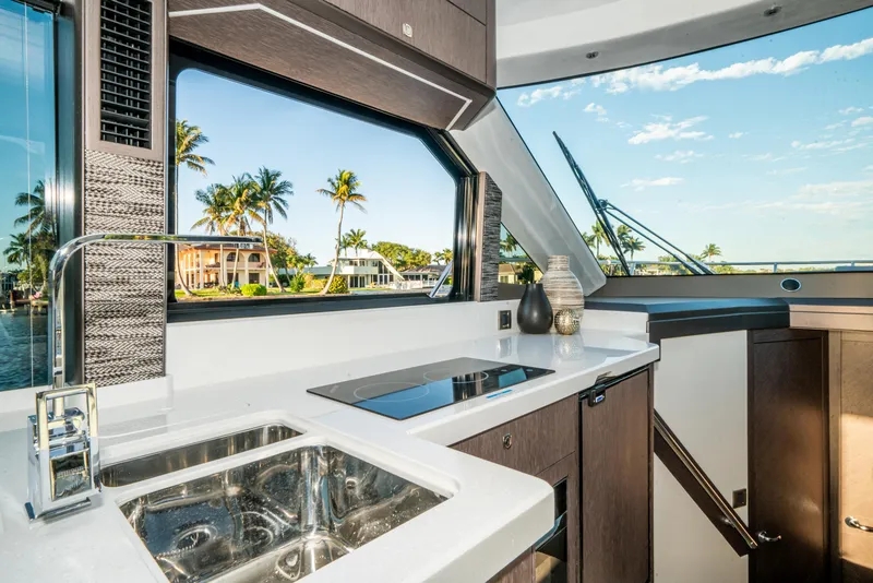Slide: The Image of Interior of 2023 Galeon 400 Fly yacht with modern kitchen and scenic view. - 28