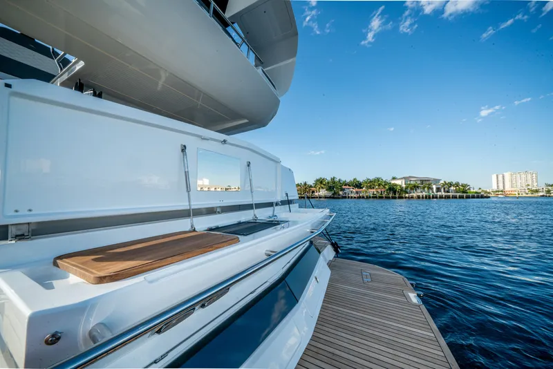 Slide: The Image of 2023 Galeon 400 Fly yacht docked by serene waterfront under clear blue sky. - 32