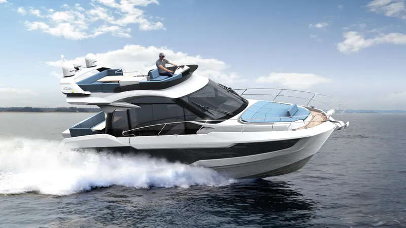 Slide: The Image of 2023 Galeon 400 Fly yacht cruising on open water under a clear sky. - 40