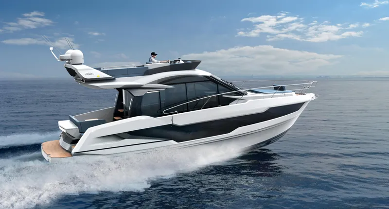 Slide: The Image of 2023 Galeon 400 Fly yacht cruising on open water under a clear sky. - 42