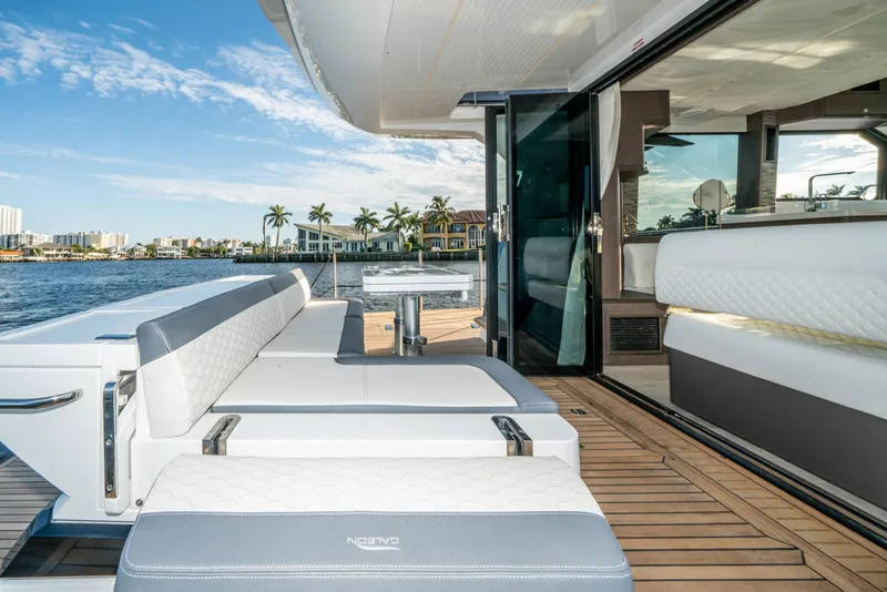 Slide: The Image of 2023 Galeon 400 Fly yacht with luxurious deck seating and scenic waterfront view. - 43