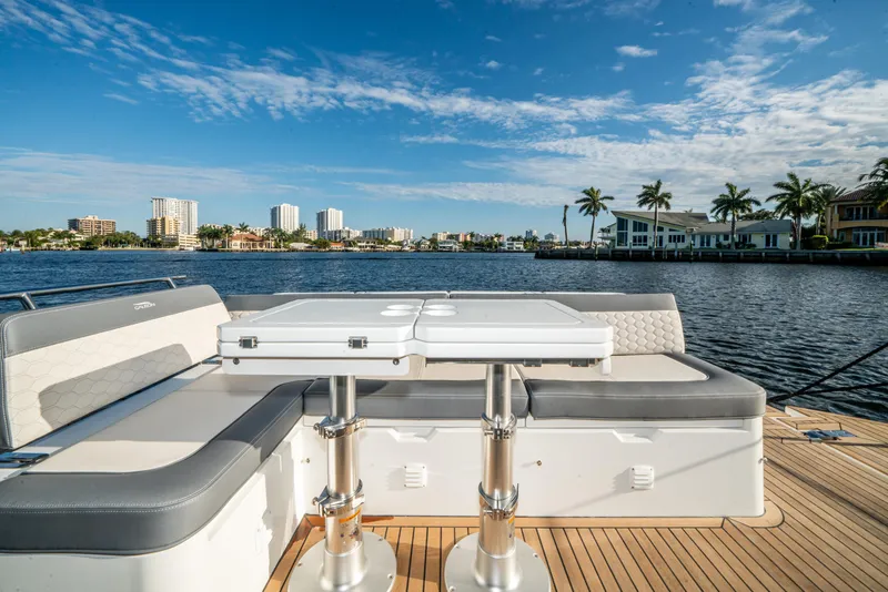 Slide: The Image of 2023 Galeon 400 Fly yacht deck with seating, overlooking waterfront cityscape. - 47
