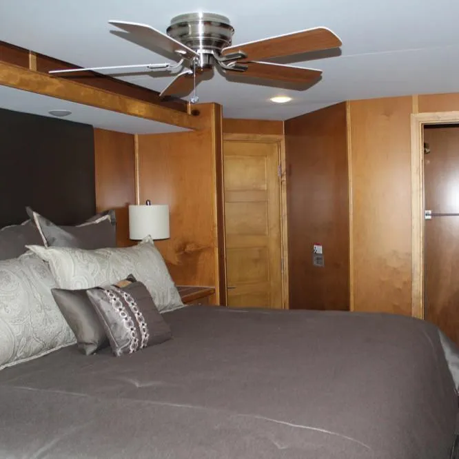 Slide: The Image of Luxurious bedroom interior in 2015 Bravada Intrepid Share #10 with wooden accents and ceiling fan. - 22