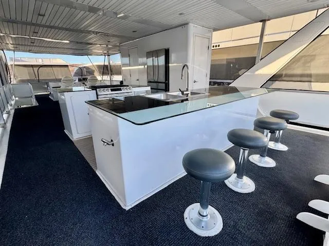 Slide: The Image of Luxurious 2015 Bravada Intrepid Share #10 yacht interior with modern kitchen and bar seating. - 25