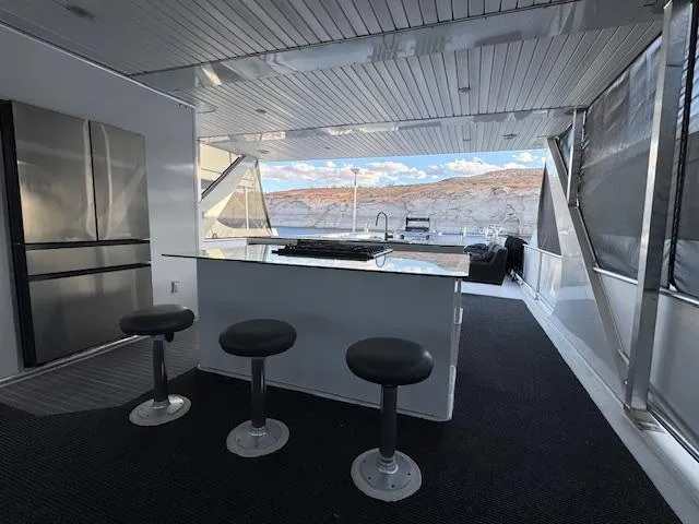 Slide: The Image of Luxurious 2015 Bravada Intrepid Share #10 houseboat interior with bar stools and scenic view. - 26