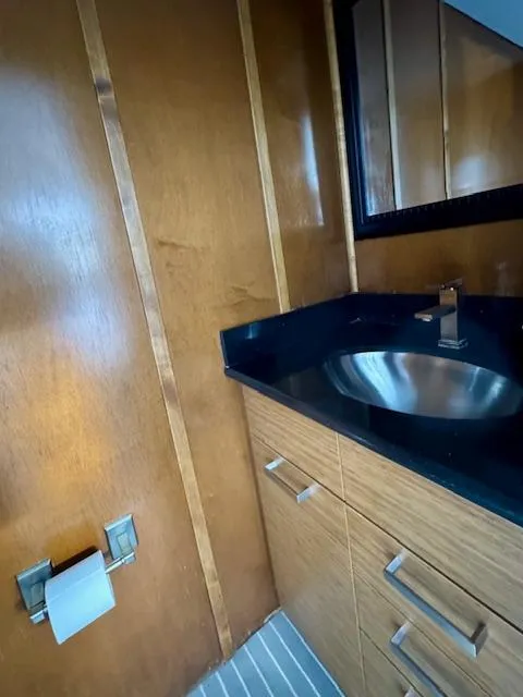 Slide: The Image of Modern bathroom with wood paneling, black countertop, and stainless steel sink in Bravada Intrepid Share #10. - 30