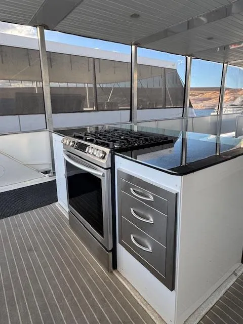 Slide: The Image of Modern kitchen on 2015 Bravada Intrepid Share #10 houseboat with stove and drawers. - 32