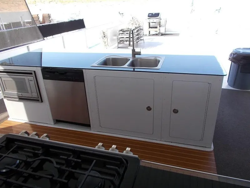 Slide: The Image of Modern kitchen on 2015 Bravada Intrepid Share #10 with sink, stove, and dishwasher. - 5