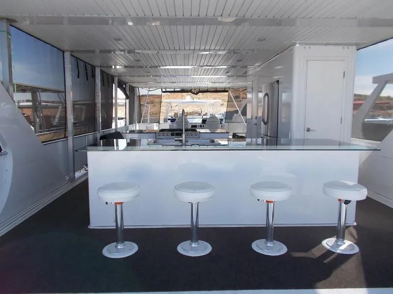 Slide: The Image of Spacious interior of 2015 Bravada Intrepid Share #10 with modern bar and seating. - 7