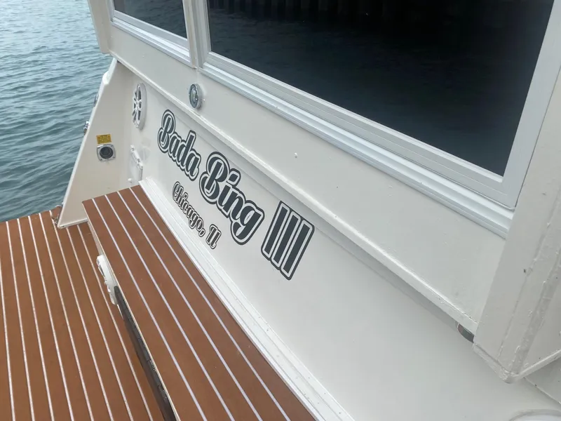Slide: The Image of Cruisers Yachts 3850 Aft Cabin 1991, boat stern with "Bada Bing III" lettering. - 10