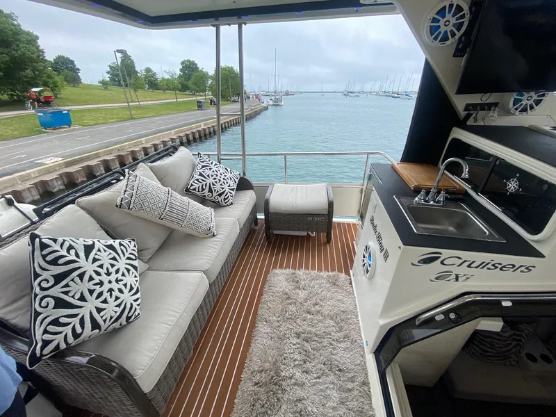 Slide: The Image of Luxurious 1991 Cruisers Yachts 3850 Aft Cabin with stylish interior by the water. - 15