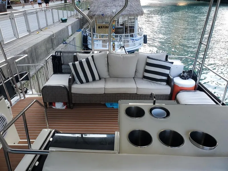 Slide: The Image of Luxurious 1991 Cruisers Yachts 3850 Aft Cabin deck with sofa and water view. - 16
