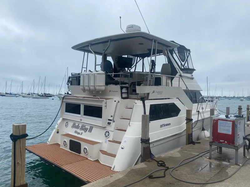Slide: The Image of 1991 Cruisers Yachts 3850 Aft Cabin docked, cloudy sky. - 18