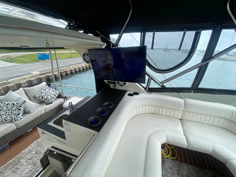 Slide: The Image of Interior of a 1991 Cruisers Yachts 3850 with white sofa and TV. - 21