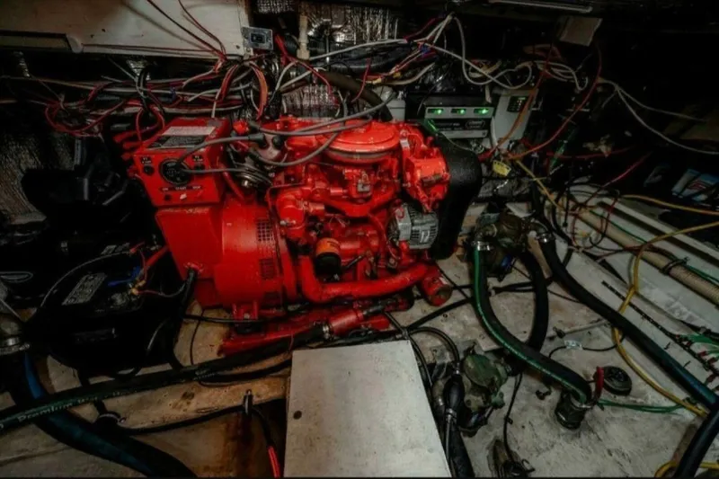 Slide: The Image of Engine room of 1991 Cruisers Yachts 3850 Aft Cabin with red machinery and wiring. - 30