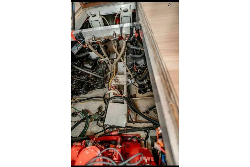 Slide: The Image of Engine compartment of 1991 Cruisers Yachts 3850 Aft Cabin with visible machinery and wiring. - 31