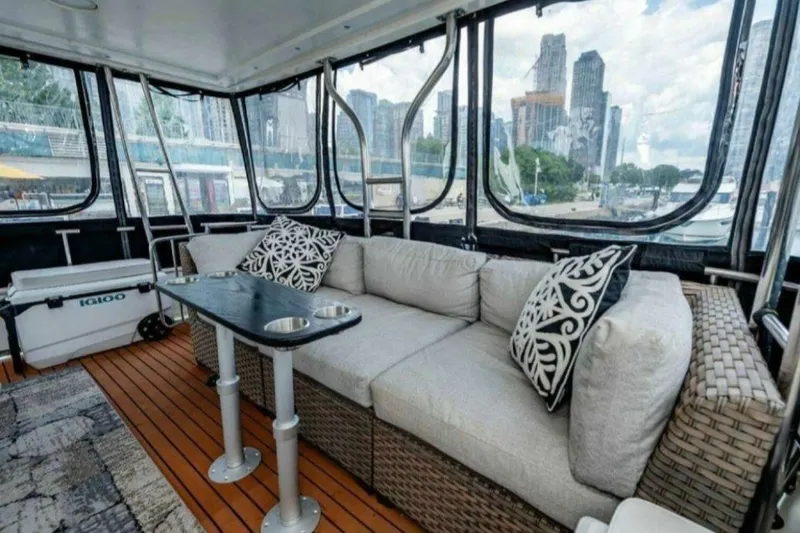 Slide: The Image of Luxurious 1991 Cruisers Yachts 3850 Aft Cabin with elegant interior and cityscape view. - 35