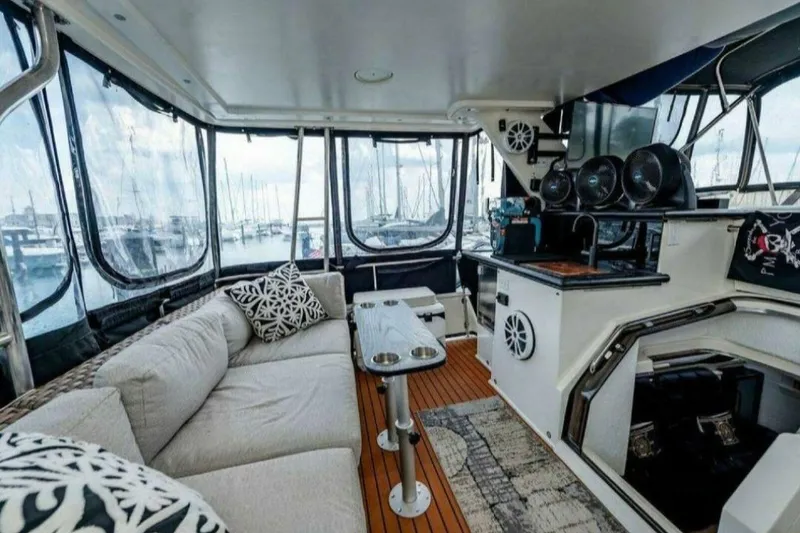 Slide: The Image of Luxurious interior of 1991 Cruisers Yachts 3850 Aft Cabin with comfortable seating and scenic marina view. - 36