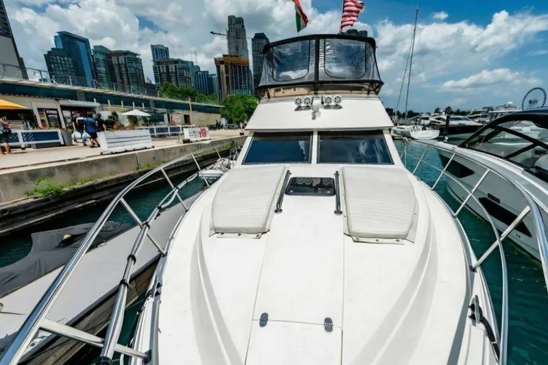 Slide: The Image of 1991 Cruisers Yachts 3850 Aft Cabin docked in urban marina with city skyline. - 4