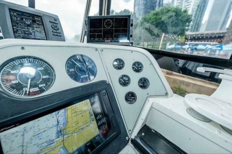 Slide: The Image of 1991 Cruisers Yachts 3850 Aft Cabin helm with gauges and navigation screens. - 40