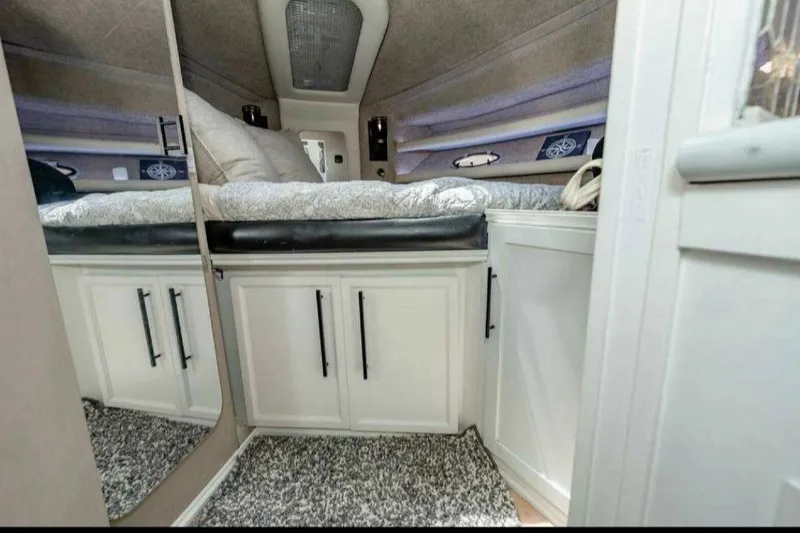 Slide: The Image of Cozy cabin interior of 1991 Cruisers Yachts 3850 Aft, featuring bed and storage cabinets. - 46