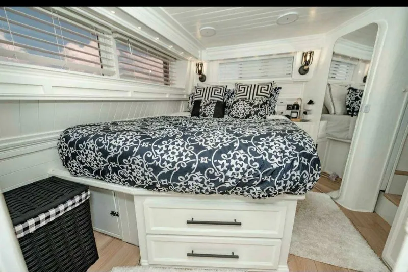 Slide: The Image of Luxurious 1991 Cruisers Yachts 3850 Aft Cabin bedroom with elegant bedding and modern decor. - 47