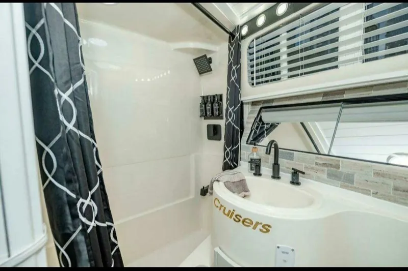 Slide: The Image of Luxurious bathroom in 1991 Cruisers Yachts 3850 Aft Cabin with modern fixtures and elegant design. - 48