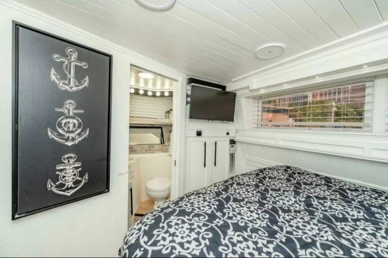 Slide: The Image of Luxurious 1991 Cruisers Yachts 3850 Aft Cabin interior with nautical decor and modern amenities. - 49