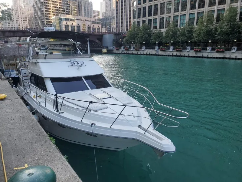 Slide: The Image of 1991 Cruisers Yachts 3850 Aft Cabin docked by city riverfront. - 5