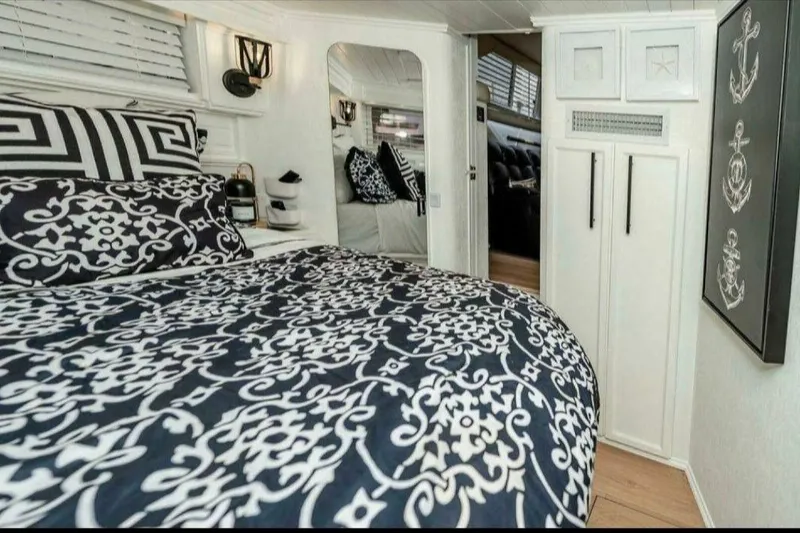 Slide: The Image of Luxurious 1991 Cruisers Yachts 3850 Aft Cabin interior with elegant bedding and nautical decor. - 50