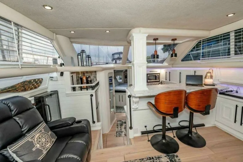 Slide: The Image of Luxurious interior of 1991 Cruisers Yachts 3850 Aft Cabin with modern furnishings and bar area. - 51