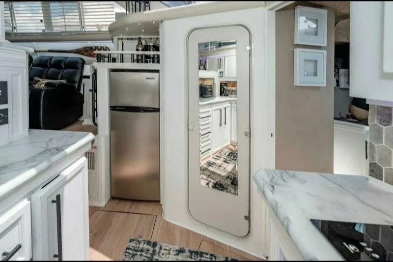 Slide: The Image of Luxurious 1991 Cruisers Yachts 3850 Aft Cabin interior with modern kitchen and sleek design. - 52