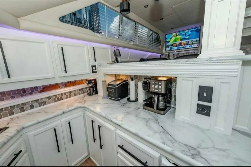 Slide: The Image of Luxurious 1991 Cruisers Yachts 3850 Aft Cabin kitchen with marble countertops and modern appliances. - 53