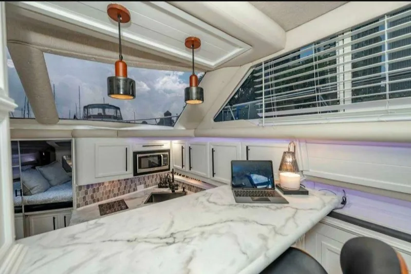 Slide: The Image of Luxurious 1991 Cruisers Yachts 3850 Aft Cabin interior with modern kitchen and marble countertop. - 54