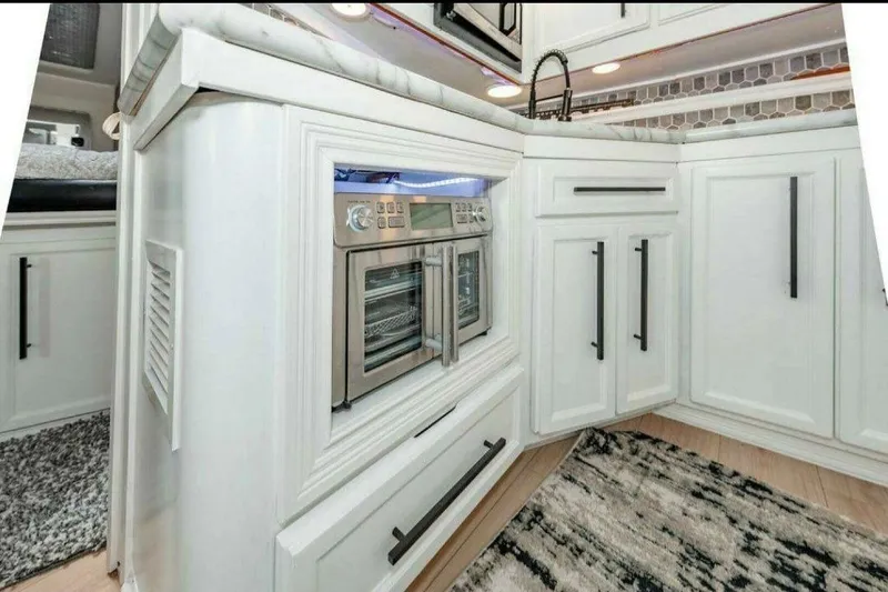 Slide: The Image of Modern kitchen interior of 1991 Cruisers Yachts 3850 Aft Cabin with sleek white cabinetry. - 55