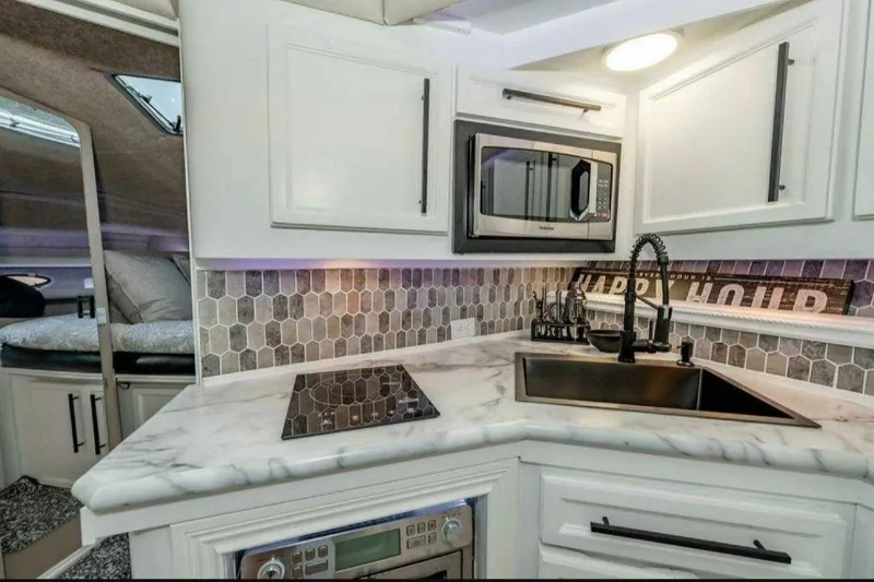 Slide: The Image of Modern kitchen in 1991 Cruisers Yachts 3850 Aft Cabin with marble countertop and hexagonal backsplash. - 56