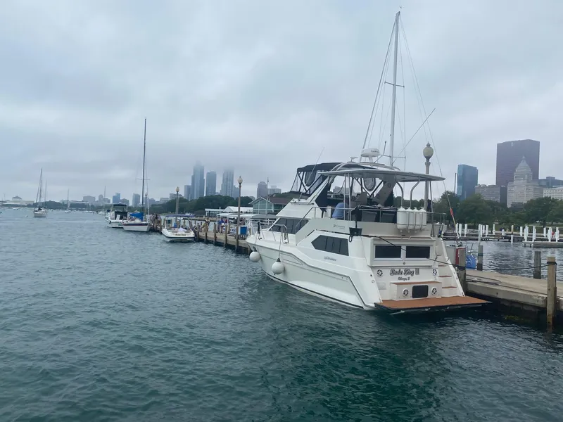 Slide: The Image of 1991 Cruisers Yachts 3850 Aft Cabin docked in urban setting. - 6