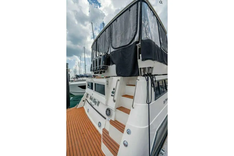 Slide: The Image of 1991 Cruisers Yachts 3850 Aft Cabin with covered upper deck at marina. - 60
