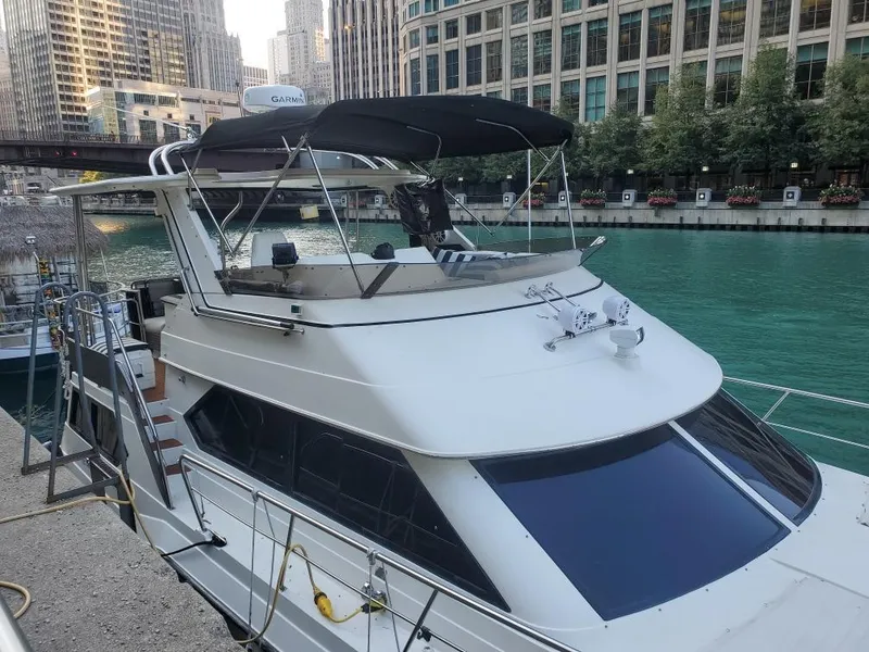 Slide: The Image of 1991 Cruisers Yachts 3850 Aft Cabin docked by the riverside. - 7